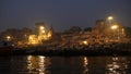 View of buildings of temples with ancient architecture of Varanasi, holy Hindu town, as seen from a moving boat in the