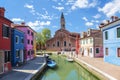 View of Burano with colorful houses and the Church of San Martino with a falling bell tower. Venice Royalty Free Stock Photo