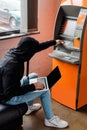 View of burglar using laptop and