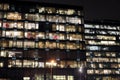 View of the burning windows of the office building at night. The work of people in the office. Urban night landscape Royalty Free Stock Photo