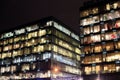 View of the burning windows of the office building at night. The work of people in the office. Urban night landscape Royalty Free Stock Photo