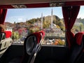 The view from the bus window on the cityscape with a mosque in Ankara Turkey. Modern passenger vehicle interior with red seats