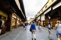 : View of the businesses located to the sides of the Bridge on the river Arno, called `Ponte Vecchio` with people walking
