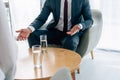 View of businessman in formal sitting in armchair