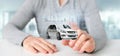 Businessman holding Dashboard smartcar interface with multimedia icon and city map on a background 3d rendering