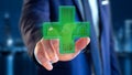 Businessman holding a Lighting pharmacy cross and a stethoscope