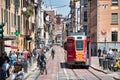 View of the busy Corso di Porta Ticinese full with trams, people during a hot sunny summer day Royalty Free Stock Photo