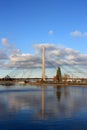 View of the cable bridge over the river Daugava. Riga, Latvia. Reflection of a cable-stayed bridge in the water against a cloudy Royalty Free Stock Photo