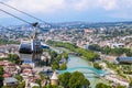 View of cable car above Tbilisi Georgia with view of Mtkvari - Kura River and Peace Bridge and city with mountains in the distance