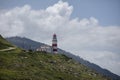 View of Cabo Silleiro lighthouse on a hill in Galicia, Spain under a cloudy sky