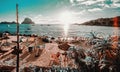 View of Cala d`Hort Beach in Ibiza. Unrecognizable tourists relaxing hanging out on the picturesque famous seaside with Es Vedra Royalty Free Stock Photo