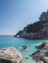 A view of Cala Goloritze beach with limestone natural arch and turquoise blue water. Famous travel destination. Gulf of Orosei, Royalty Free Stock Photo