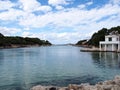 View of Cala Santandria in a bright cloudy day in Menorca Spain