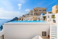 A view of caldera with luxury hotel buildings, typical white architecture of Firostefani village on Santorini island, Greece Royalty Free Stock Photo