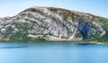 View at calm bay in Norway, between Nesna and Maela villages, blue water of Atlantic ocean, mountains, Calm sunny summer day