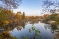 view of a calm river, autumn, Sunny day. In the foreground are beautiful twigs and leaves. Reflection Royalty Free Stock Photo