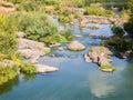 View of a calm river with rocky banks and rapids Royalty Free Stock Photo
