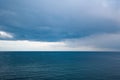 Dramatic seascape with grey cloudy sky and boat in distance Royalty Free Stock Photo