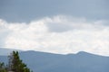 View of calming mountain valley with ridge on horizon. Gentle hills