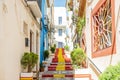 View of Calpe old town on sunny day. Stairs adorned with colors of Spanish flag, Calpe, Alicante province, Valencian Royalty Free Stock Photo