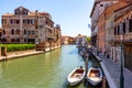 View of the canal with boats and gondolas in Venice, Italy. Venice is a popular tourist destination of Europe Royalty Free Stock Photo