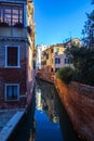 View of a Canal with boats and gondolas in Venice, Italy. Venice is a popular tourist destination of Europe. Royalty Free Stock Photo