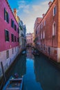 View of a Canal with boats and gondolas in Venice, Italy. Venice is a popular tourist destination of Europe. Royalty Free Stock Photo