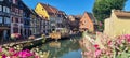 View on the canal framed by colourful flowers in little Venice in Colmar, Alsace, France Royalty Free Stock Photo