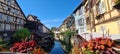 View on the canal framed by colourful flowers in little Venice in Colmar, Alsace, France Royalty Free Stock Photo