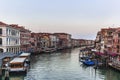 View of the Canal Grande its palaces, and the water ferry station of Rialto in Venice at sunrise from the Rialto Bridge