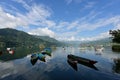 View of canoes on Phewa Tal, a freshwater lake in Nepal, and surrounding hills in Pokhara Valley Royalty Free Stock Photo