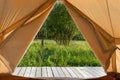 View from the canvas tent upon the green meadow Royalty Free Stock Photo