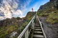 View on Cape Palliser red and white striped lighthouse with steep wooden stairs leading to it