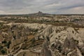 View of Cappadocia from above. In the valley there are high cylindrical rocks