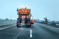 View from the car behind orange highway maintenance truck Royalty Free Stock Photo