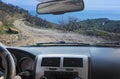 View from the car on a dangerous dirt winding road by the sea Royalty Free Stock Photo