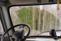 The view from the car through the dirty windshield of the forest. View from the drivers seat of the truck Royalty Free Stock Photo