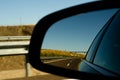 View in the car mirror on fast road in the Spain, beautiful landscape