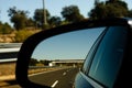 View in the car mirror on fast road in the Spain, beautiful landscape