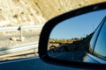 View in the car mirror on fast road in the Spain, beautiful landscape