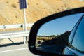 View in the car mirror on fast road in the Spain, beautiful landscape