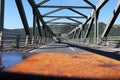 View from the car on the road and the steel bridge in Scottish Highlands