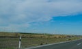 View from the car to a great empty highway and wind turbines Royalty Free Stock Photo