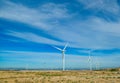 View from the car to a great wind turbines for produce electricity Royalty Free Stock Photo