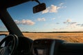 View from car window on the field at sunset Royalty Free Stock Photo