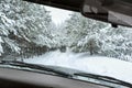 View from car window on off-road vehicle driving on winter forest road, snow covered trees. Extreme winter sport, travel Royalty Free Stock Photo