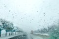 View from the car window on the snow-covered track. Road view through car window during snowfall. Royalty Free Stock Photo