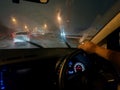 View from the car window to the road covered by raindrops while driving car Royalty Free Stock Photo