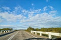 View from car windscreen with stripe relief to highway, tundra and blue sky in norht region at a sunny day Royalty Free Stock Photo