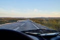 View from car windscreen to highway and tundra in evening time Royalty Free Stock Photo